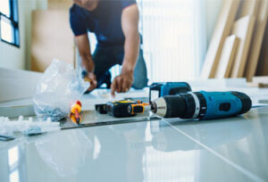 man in the middle of a Custom Kitchen Cabinets  job on a white countertop in Farmington Hills