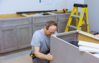 Contractor installing custom cabinets at a home in Sterling Heights, MI