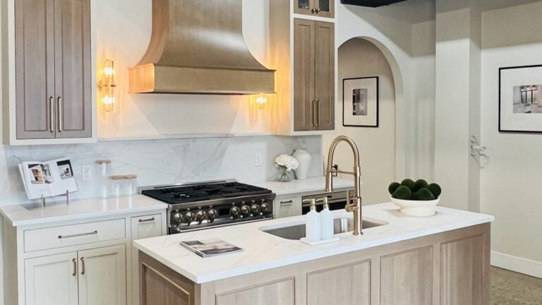 A white oak kitchen with quartz countertops.