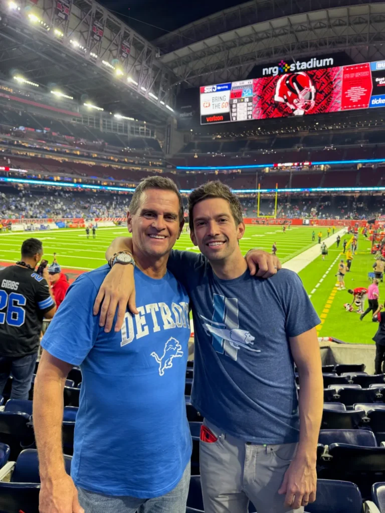 Picture of founders at football game in the stadium.