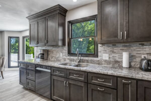 Dark Wood Cabinets with Gray Counters and Backsplash for a Kitchen Cabinet Design in Birmingham, MI