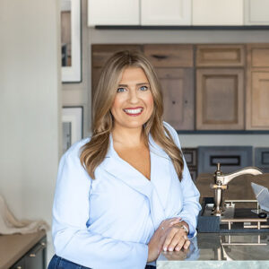 Kelsey Powell standing in an Exclusively Cabinets showroom